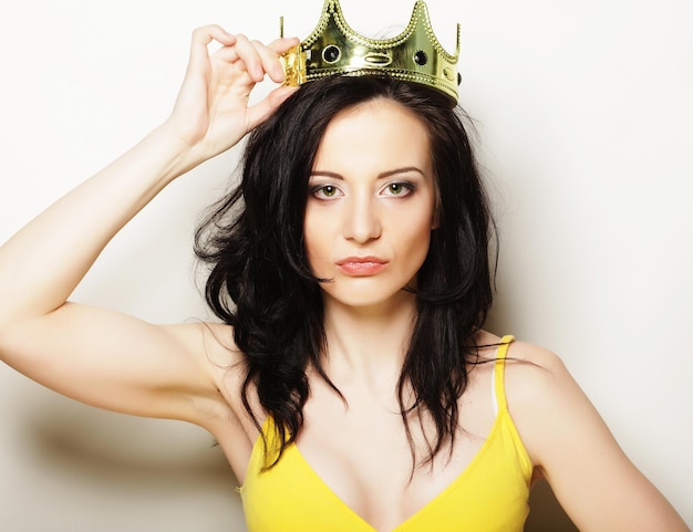 Pretty brunette woman wearing crown