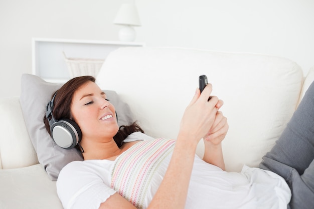 Pretty brunette woman writing a text on her mobile