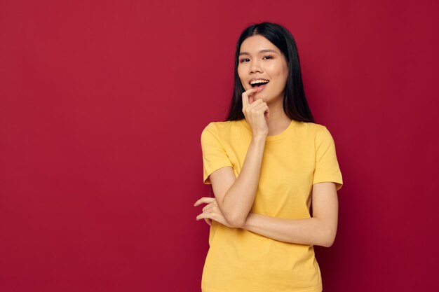 Pretty brunette in a yellow tshirt gesturing with his hands fun isolated background unaltered