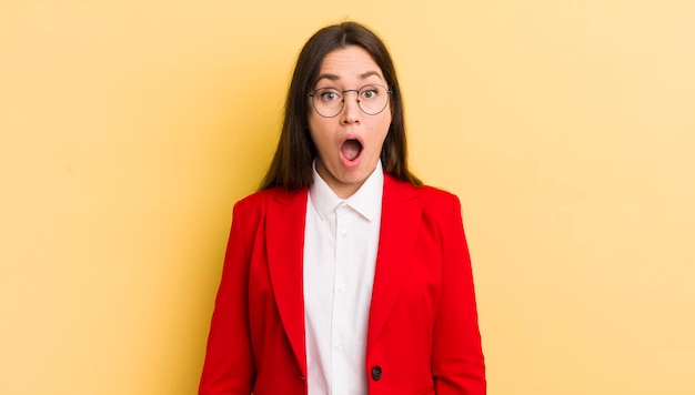 pretty businesswoman against yellow wall