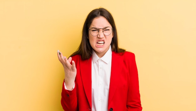 pretty businesswoman against yellow wall