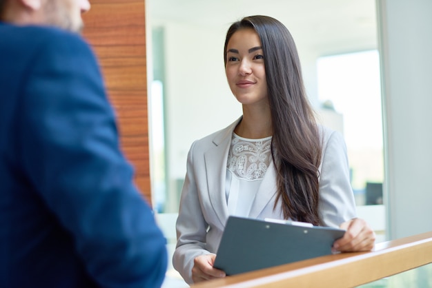 pretty businesswoman chatting with colleague