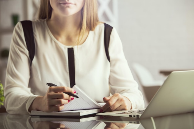 Pretty businesswoman doing paperwork