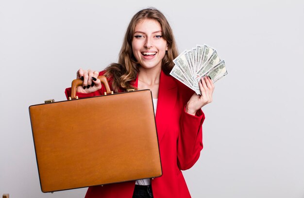 Pretty businesswoman with bills and a suitcase