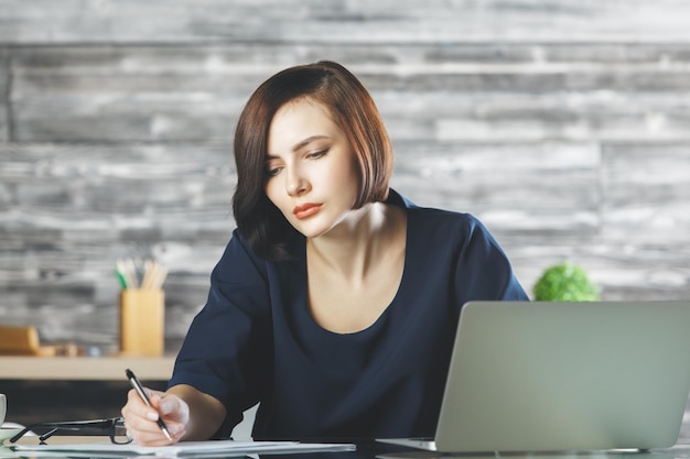 Pretty businesswoman working on project