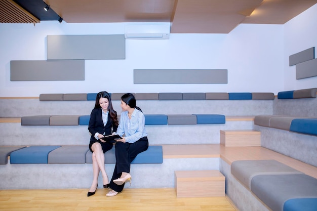 Pretty businesswomen discussing a document happily