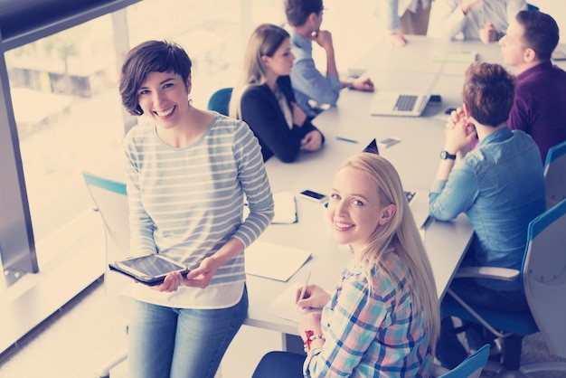 Pretty Businesswomen Using Tablet In Office Building during conference