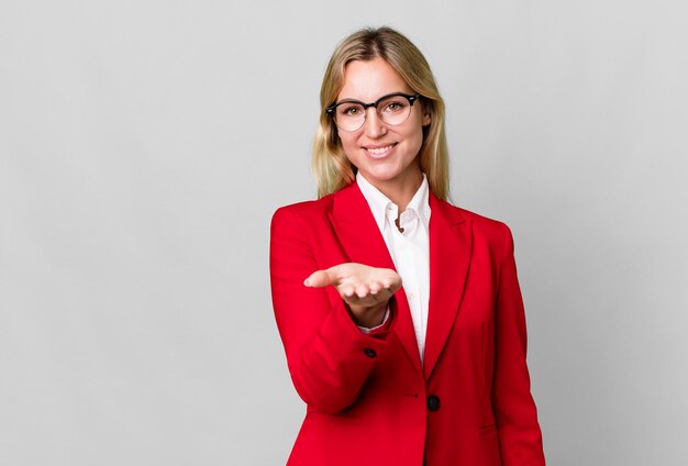 Pretty caucasian blonde businesswoman with red blazer