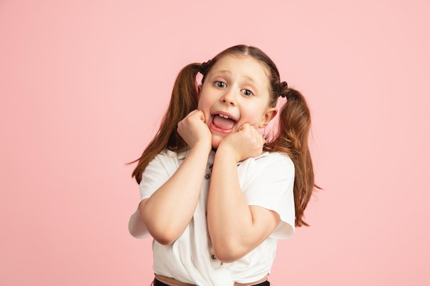 Pretty caucasian girl portrait isolated on pink studio background with copyspace