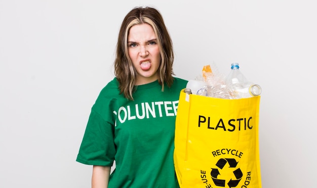 Pretty caucasian woman feeling disgusted and irritated and tongue out ecology concept