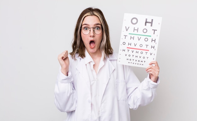 Pretty caucasian woman feeling shockedlaughing and celebrating success optical concept