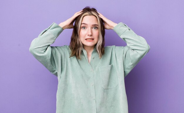 Photo pretty caucasian woman feeling stressed worried anxious or scared with hands on head panicking at mistake