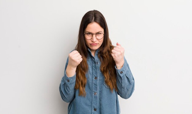 Pretty caucasian woman looking confident angry strong and aggressive with fists ready to fight in boxing position