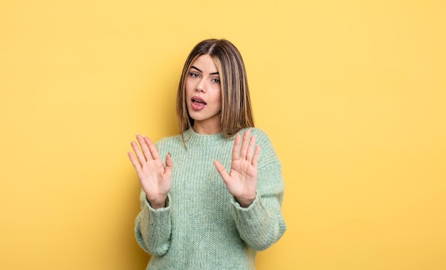 Pretty caucasian woman looking nervous, anxious and concerned, saying not my fault or I didnât do it