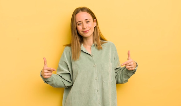 Pretty caucasian woman looking proud arrogant happy surprised and satisfied pointing to self feeling like a winner