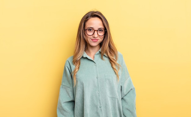 Pretty caucasian woman looking proud, confident, cool, cheeky and arrogant, smiling, feeling successful