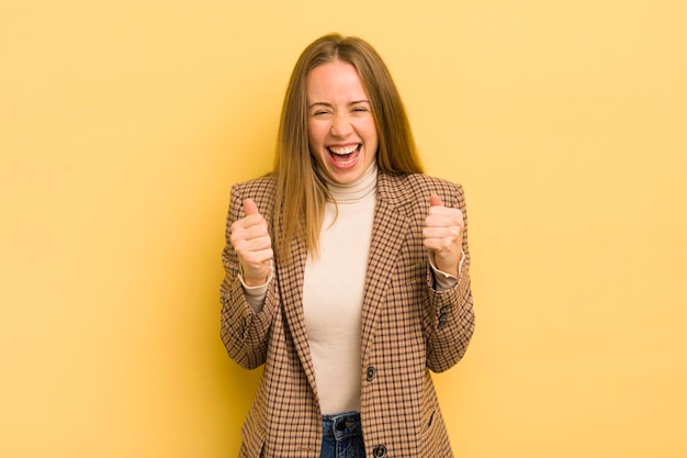 Pretty caucasian woman shouting aggressively with annoyed frustrated angry look and tight fists feeling furious