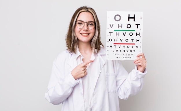 Pretty caucasian woman smiling cheerfully feeling happy and pointing to the side optical concept