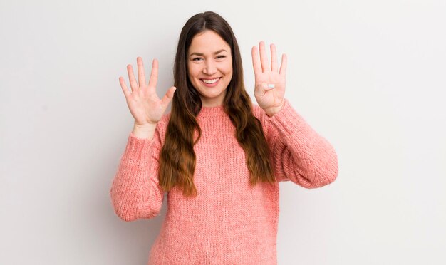 Pretty caucasian woman smiling and looking friendly showing number nine or ninth with hand forward counting down