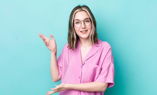 Pretty caucasian woman smiling proudly and confidently feeling happy and satisfied and showing a concept on copy space