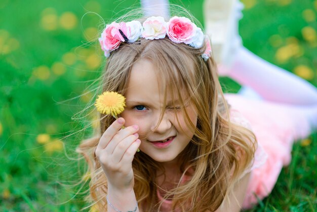 Pretty child girl smiling and playing in flowers of the garden, blooming trees, cherry, apples.