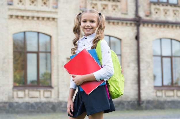 Pretty child little girl going to read study literature for children learn with document folder knowledge day modern school education happy childhood teen girl with book