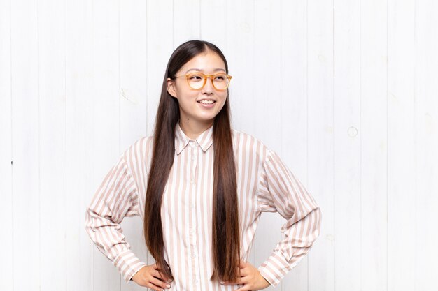 pretty chinese woman against white wall