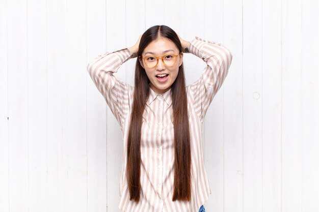 pretty chinese woman against white wall