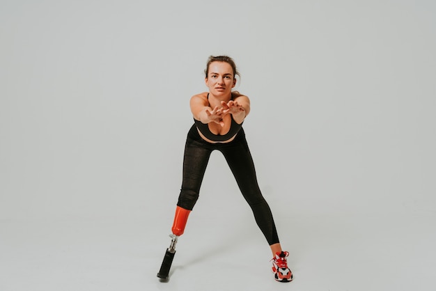 Pretty and confident woman with leg disability doing exercises