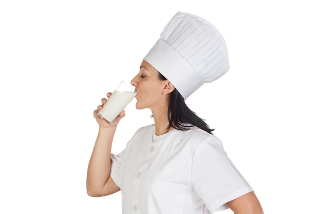 Pretty cook girl drinking milk isolated on white background