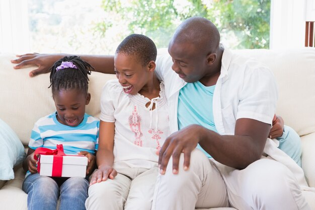 Pretty couple offer a presente for their daughter 