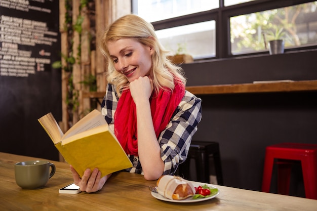 Pretty customer reading a book