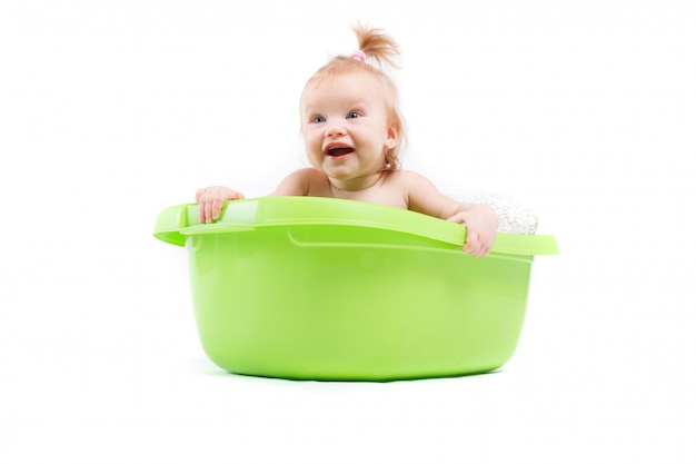 Pretty cute baby girl take bath in green tub