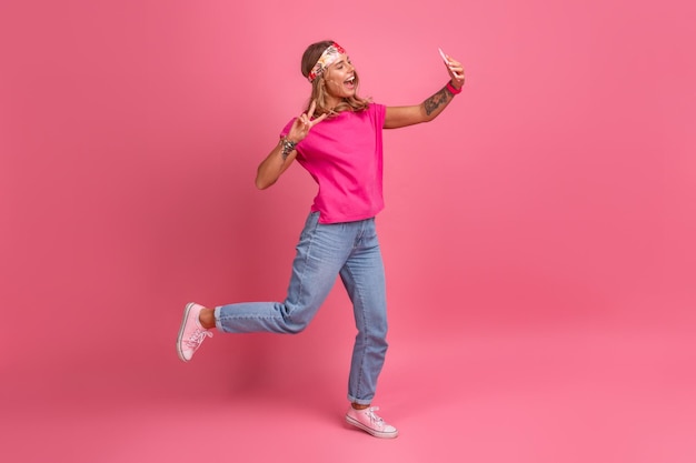 Pretty cute smiling woman in pink shirt boho hippie style accessories smiling