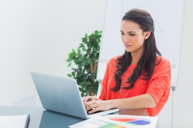 Pretty designer working on her laptop