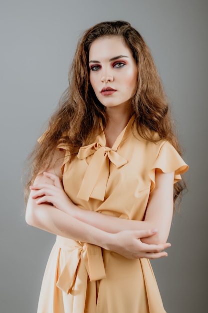 Pretty emotional woman isolated over grey wall