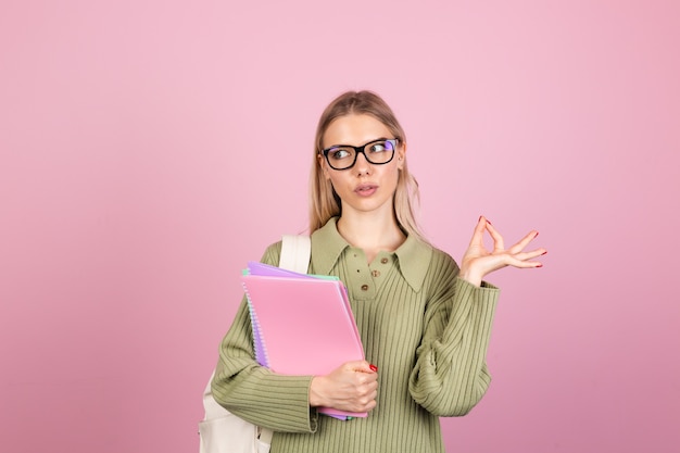 Pretty european woman in casual sweater on pink wall