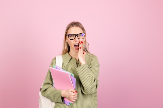 Pretty european woman in casual sweater on pink wall