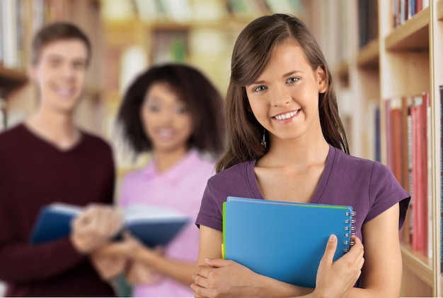 Pretty Female Student Surrounded by Library Books