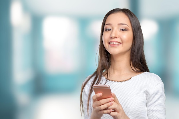 Pretty female teenager using smartphone