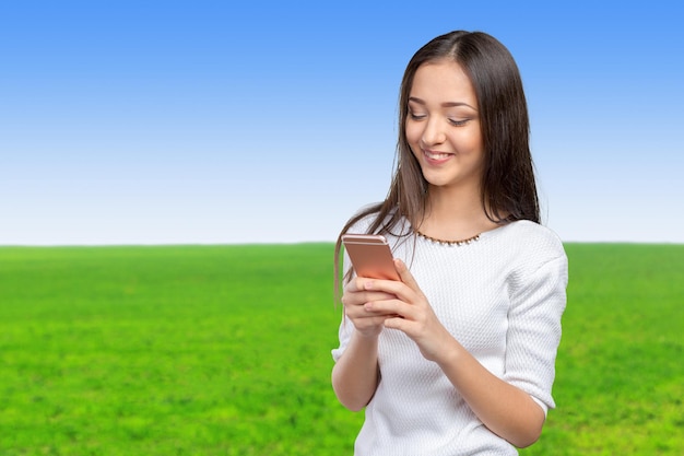 Pretty female teenager using smartphone