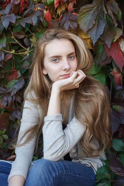 Pretty female with brown hair posing outdoors