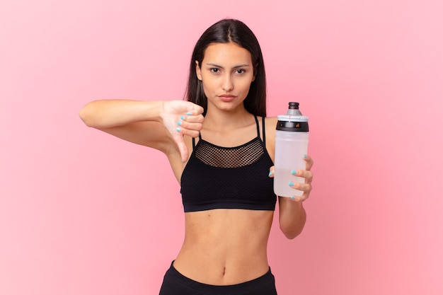 Pretty fitness woman with a water bottle