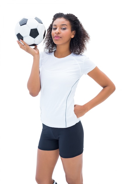 Pretty football fan in white holding ball 