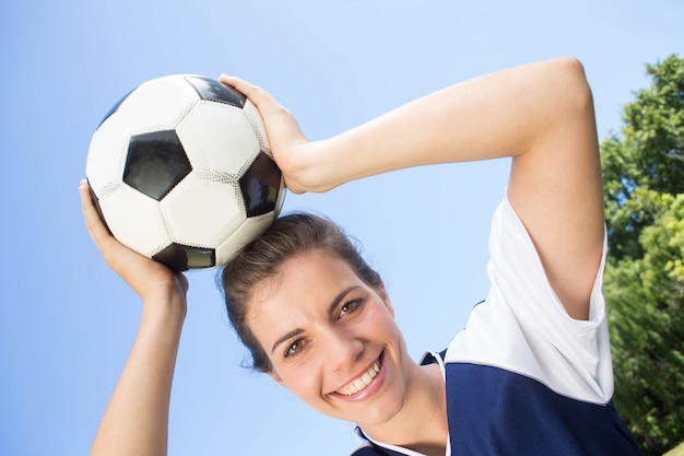 Pretty football player smiling at camera