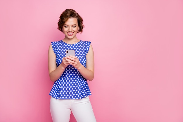 pretty foxy redhead lady hold telephone on pink wall