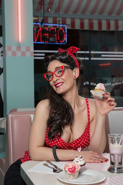 Pretty and friendly Pinup girl in a 50s restaurant setting