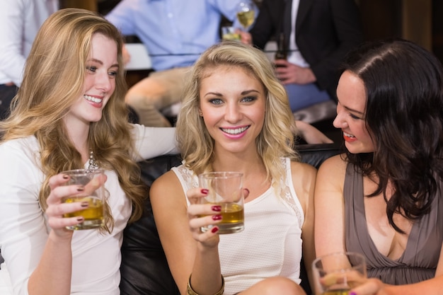 Pretty friends having a drink together