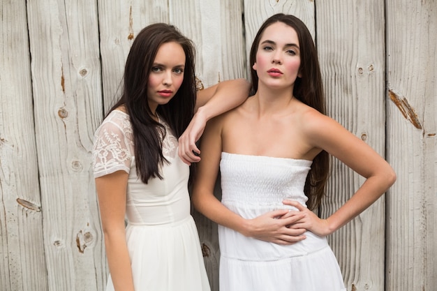 Pretty friends posing in white dresses