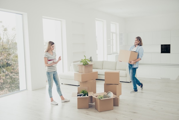 Pretty girl choosing where to put belongings things indoors